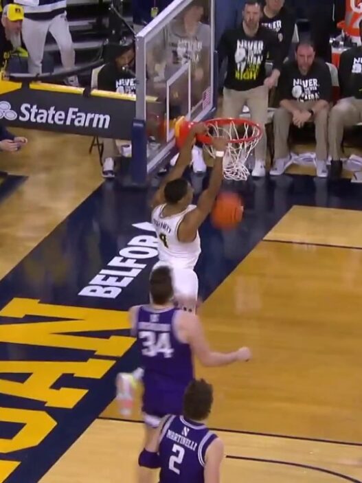 Michigans Nimari Burnett launches two handed slam in overtime to extend