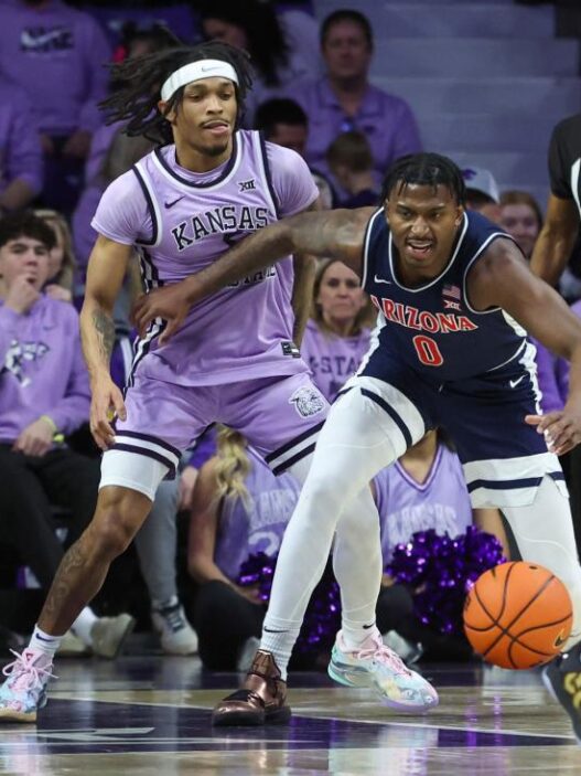 The Kansas State basketball goalkeeper Dug McDaniel embraces his new