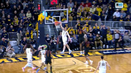 Danny Wolf of Michigan throws the dunk to cut the