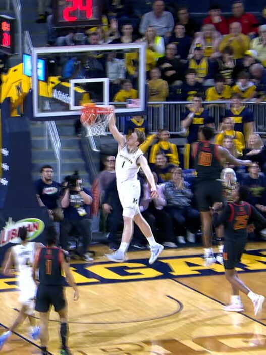 Danny Wolf of Michigan throws the dunk to cut the