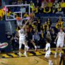 Jordan Geronimo of Maryland puts the Michigan defender on a